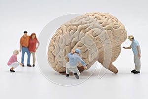 miniature figurines of people with an human brain