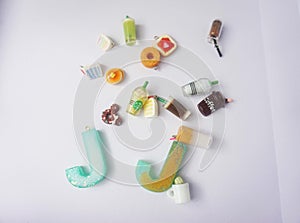 miniature food and alphabet made of clay and resin with colorful toys on white background