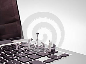 Miniature Forensics Experts Examining Laptop Keyboard 