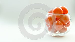 Miniature glass jar full of small tomatoes