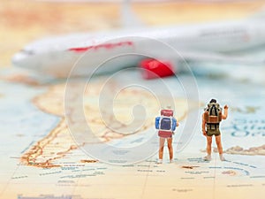 Miniature Group traveler with backpack standing