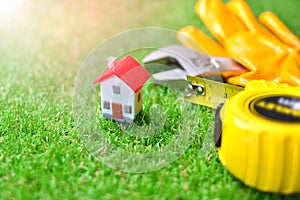 Miniature house with a building equipment on a grass