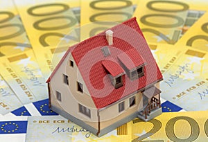 Miniature house on Euro bills