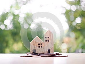 Miniature house on stack of coins. The concept of saving money for house, Property investment, House mortgage, Real estste