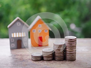 Miniature house and stack of coins. The concept of saving money for house, Property investment, House mortgage, Real estste