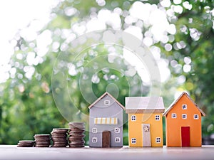 Miniature house and stack of coins. The concept of saving money for house, Property investment, House mortgage, Real estste