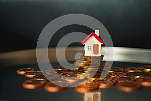 Miniature house on stack coins using as business and property co