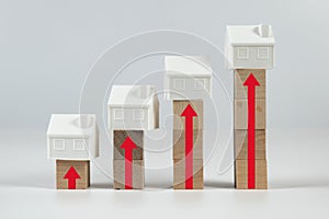 Miniature houses on blocks showing rising house prices