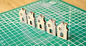 Miniature houses on a cutting mat. Home renovation and reconstruction concept.