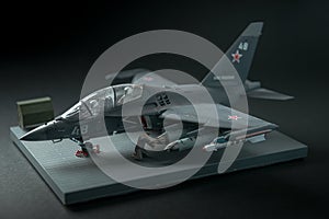 Miniature of military fighter on a black background with place for text