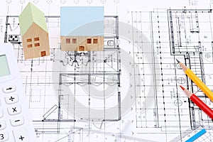 Miniature model of house on blueprints