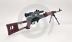 A miniature model of military sniper automatic gun in small-scale photo