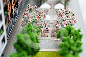Miniature model, miniature toy buildings, cars and people. City maquette.