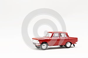 Miniature model of a red retro car on a white background