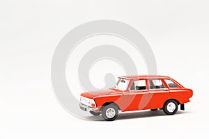 Miniature model of a red retro car on a white background