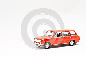 Miniature model of a red retro car on a white background