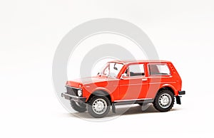 Miniature model of a red retro car on a white background