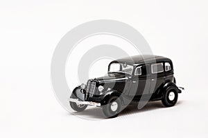 Miniature model of a retro car on a white background