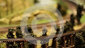 Miniature Model Scale Railway, Train with wagons is driving, blurred motion