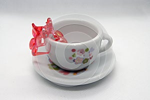 Miniature model of a tea cup. Kids playing tea set.