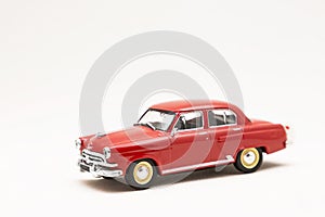 Miniature model of a vintage retro car toy on a white background