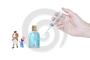 Miniature mother and children with bottle of ethyl alcohol and new syringe in girl hand isolate on white background