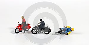 Miniature motorcycle driver who crashed. Concept about the risk of motorcycle accidents.