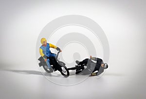 Miniature motorcycle rider. Miniature motorcycle driver who crashed. photo