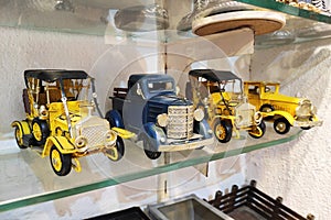 Miniature multi-colored collectible models of vintage cars in the shop window