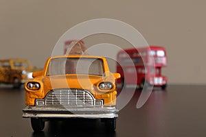 Miniature of New Yourk yellow taxi cab with Londo double bus at background