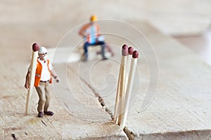 Miniature people in action with matchsticks