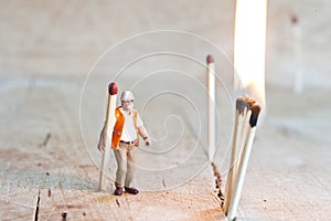 Miniature people in action with matchsticks