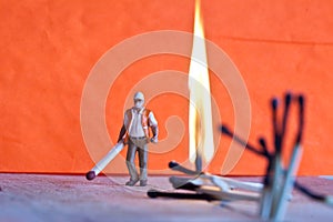 Miniature people in action with matchsticks