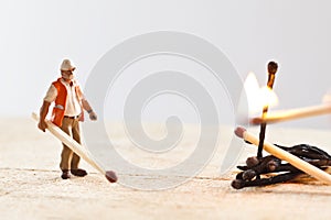 Miniature people in action with matchsticks