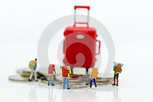 Miniature people : Backpacker group walking on coins. Image use for travel, business concept