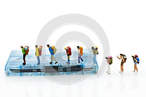 Miniature people: backpacker walking on Compact Cassette. Image use for music of travel, business concept