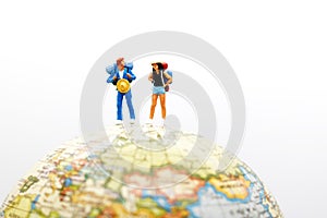 Miniature people, backpackers on the globe walking to destination. travel and business concept.