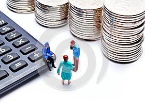 Miniature People: Business people`s with calculator and coin stacks