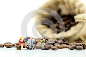 Miniature people : business team sitting on coffee beans,relax c