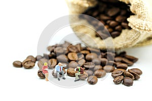 Miniature people : business team sitting on coffee beans,relax c