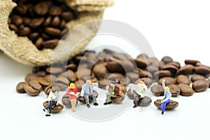 Miniature people : business team sitting on coffee beans,relax c