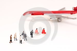 Miniature people, businesses team walking to airplane