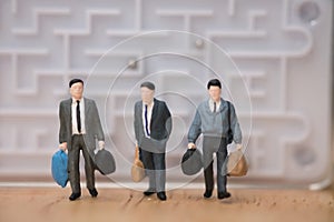 Miniature people: Businessman leave from maze to the future concept