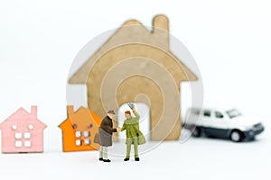 Miniature people: Businessman make deal for loan ,buy house. Image use for finance, business concept