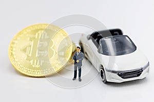 Miniature people: Businessman planning success deal business with Gold bitcoin.  Concept of Business, Money, Technology,