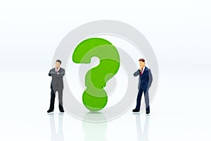 Miniature people : Businessman and question mark. Image use for find answers, solution, business concept