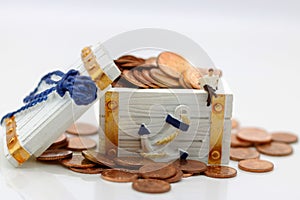 Miniature people: Businessman sitting on block with coins. Business and education concept.