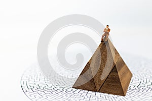 Miniature people: Businessman sitting on graphs with maze map, profit margins of background, risk. Image use for business