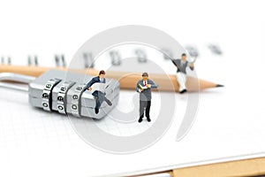 Miniature people: Businessman sitting on master key encoding. Image use for background security system, hack, business concept