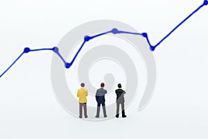 Miniature people: Businessman stand front of dashboard, display graphs, profit margins of background. Image use for business